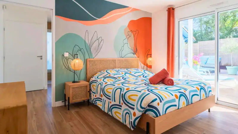 Chambre colorée ouverte sur la terrasse et la piscine – Capbreton